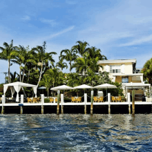 a large house sits on the shore of a lake