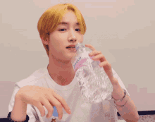 a young man drinks water from a bottle that says icepro on it