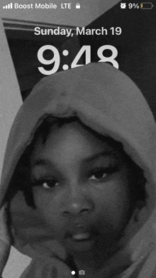 a black and white photo of a girl with a hoodie on sunday march 19th