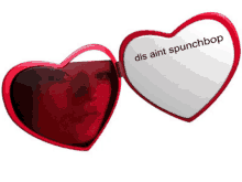 a red heart shaped mirror with the words dis aint spunchbop on it