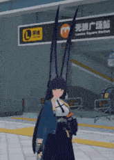 a woman with long black hair is standing in front of a sign that says lumina square station .