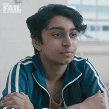 a young man sitting with his arms crossed in front of a sign that says how to fail as a pop star