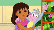 dora the explorer is holding a monkey in her arms and waving .