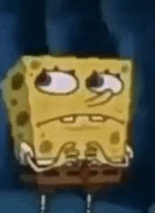 spongebob squarepants is making a funny face with his eyes closed .