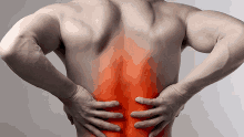 a shirtless man is holding his back in pain with a red spot highlighted