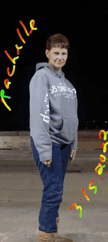 a woman wearing a grey hoodie with the name michelle written on it