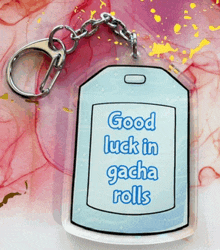 a keychain with the words good luck in gacha rolls on it