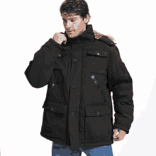 a man in a black parka with a fur hood