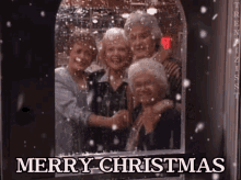 a group of elderly women are standing in front of a window with the words merry christmas written on it