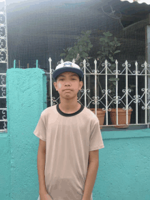 a young boy wearing a hat that says mlb on it