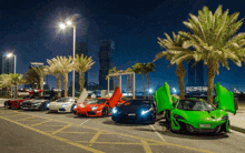 a green sports car with a license plate that says ' aa ' on it is parked in a parking lot with other cars