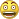 a close up of a yellow smiley face with a surprised expression on its face .