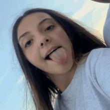 a girl is sticking her tongue out in a selfie