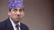 michael scott is wearing a purple bandana on his head .