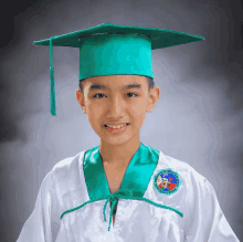 a young boy wearing a graduation cap and gown has a badge on his shirt that says ' philippines '