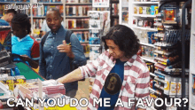 a man in a plaid shirt with the letter b on it is looking at books in a comic book store