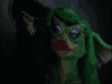 a close up of a green gremlin with green hair and red lips