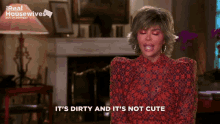 a woman says " it 's dirty and it 's not cute " in front of a fireplace