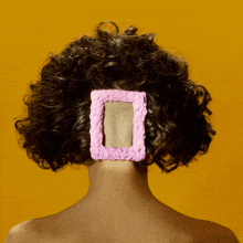 a woman has a pink frame in her hair