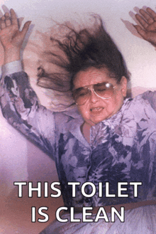 a woman wearing sunglasses and a purple shirt with the words this toilet is clean underneath her