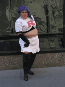 a woman in a pokemon costume is standing in front of a window .