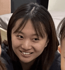 a close up of a woman 's face with a smile