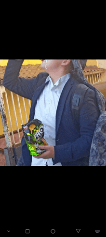 a man in a suit is holding a bag of nacho cheese