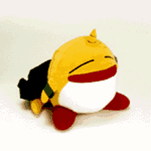 a yellow and white stuffed animal with a red nose