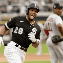 a baseball player with the number 28 on his jersey is smiling