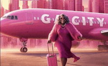 a woman in a pink fur coat is standing in front of a pink plane that says city