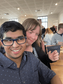 a man and a woman are posing for a picture