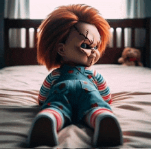 a chucky doll is sitting on a bed in a bedroom