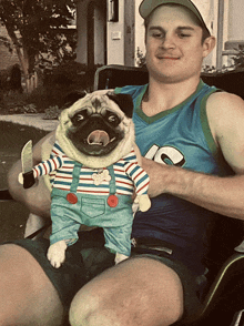 a man holding a pug wearing overalls and a shirt that says 10