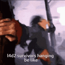 a blurry picture of a person holding a gun with the words l4d2 survivors hanging be like