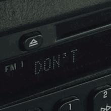 a close up of a radio with the words `` fm 1 don 't '' on it .