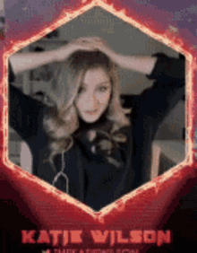 a picture of katie wilson in a red hexagon frame