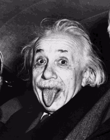 albert einstein sticks his tongue out in a black and white photo