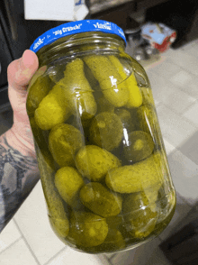 a jar of pickles with a blue lid that says pig crunch on it