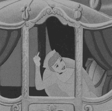 a black and white photo of cinderella giving the middle finger while laying in a carriage .