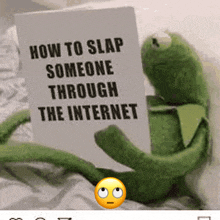 a kermit frog is holding a sign that says how to slap someone through the internet