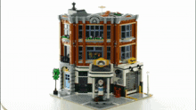 a lego model of a building with a gas pump in front of it