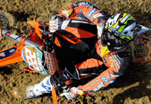 a man riding a dirt bike with the number 25 on the front