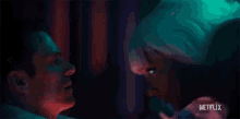 a man and a woman are kissing in a dark room in a netflix trailer .