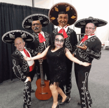 a group of mariachi singers pose for a picture