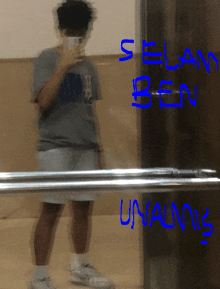 a blurry picture of a person taking a selfie with the words elan ben written in blue