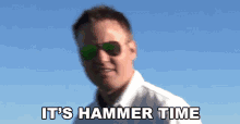 a man wearing sunglasses and a white shirt says " it 's hammer time "