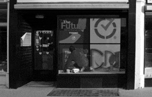 a black and white photo of a man painting a window for the future workers podcast