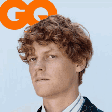 a man with red curly hair is on the cover of a magazine called gq