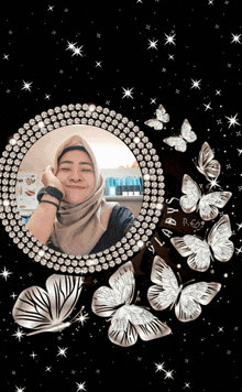 a picture of a woman in a hijab is surrounded by butterflies and diamonds