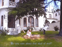 two women are sitting on the grass in front of a white house with the words do you care about that kind of stuff